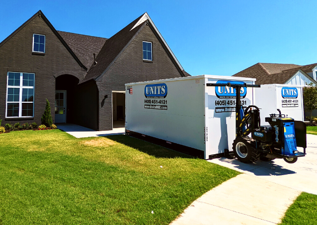 Two Units of Oklahoma City containers sitting in the driveway of a house.