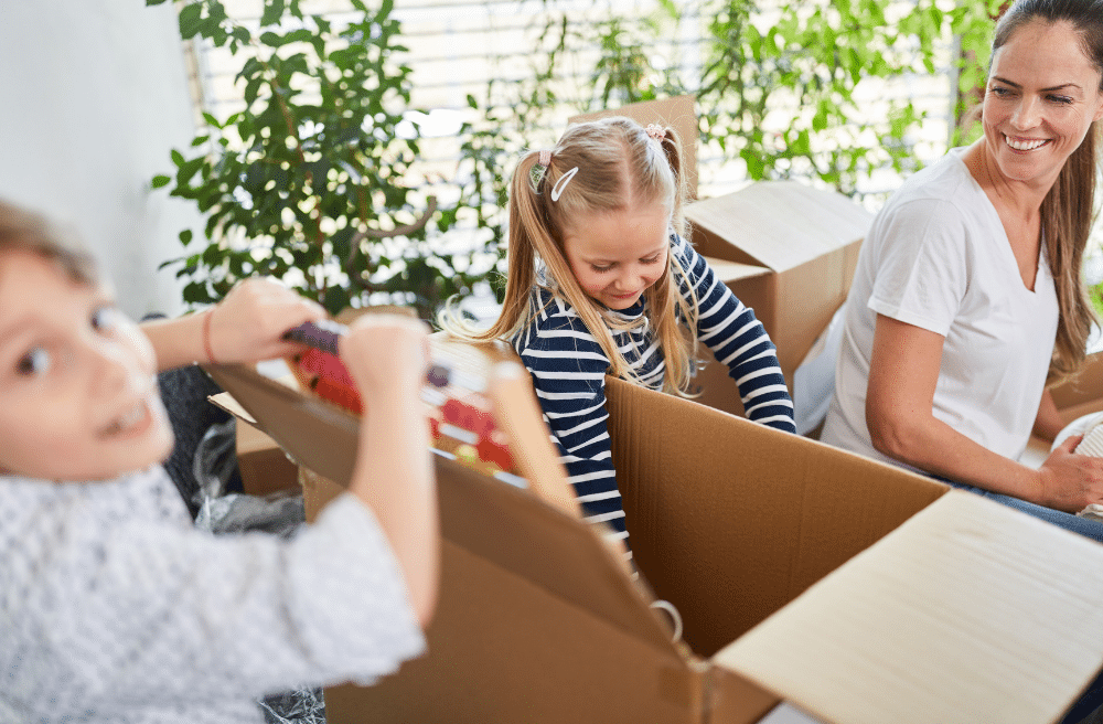 A family helping unpack items from boxes.