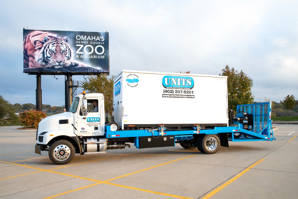 Units of Omaha & Lincoln truck parked in a parking lot outside of a zoo