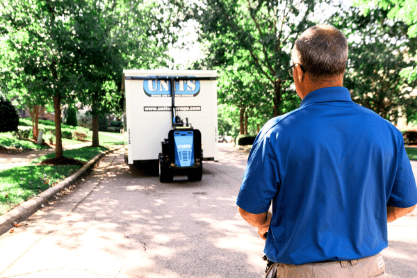 Man using a ROBO-UNIT to move a UNITS Moving and Portable Storage container.