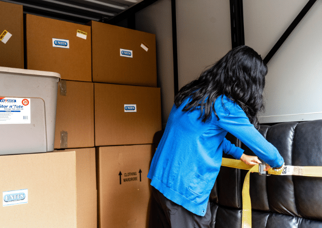 Woman securing things in her portable storage container.