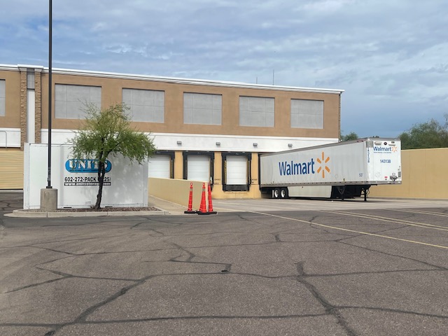 UNITS Moving and Portable Storage of Phoenix container next to a Walmart truck behind a building.