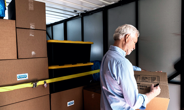 Man labeling boxes inside his UNITS Moving and Portable Storage of Phoenix container.