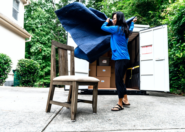 Woman preparing to store a wooden chair in a UNITS Moving and Portable Storage of Phoenix container.