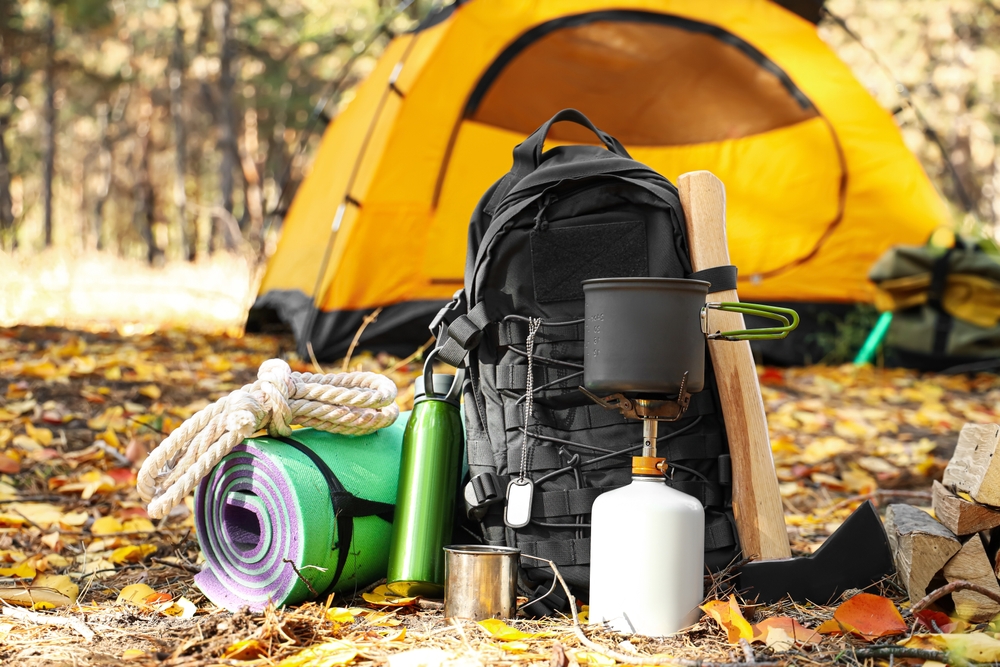 Camping gear in front of a tent.