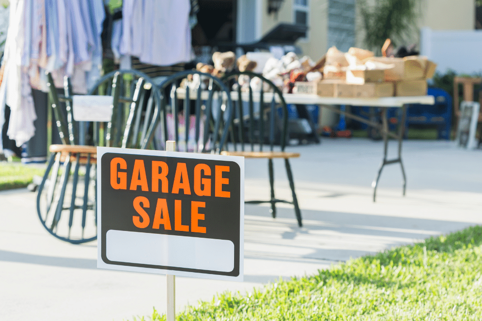 Grage sale sign in front of a garage sale.