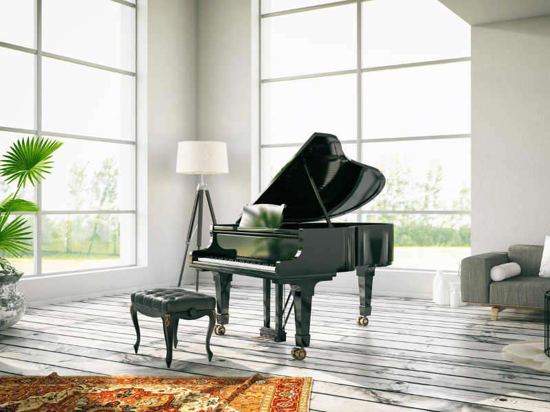 Piano sitting in a mostly empty room.