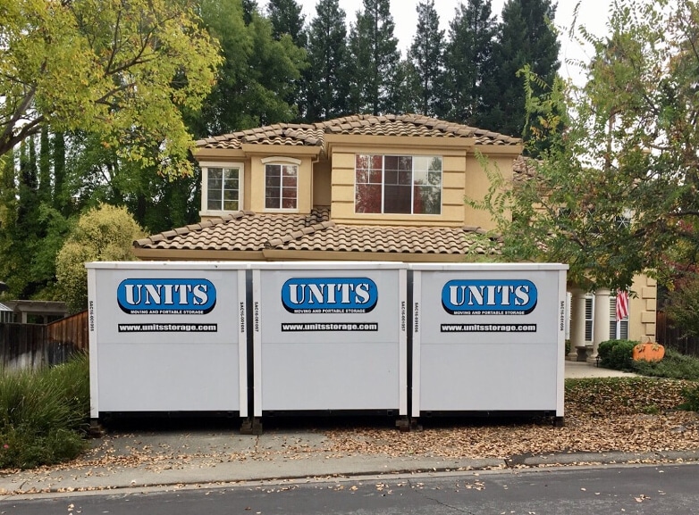 Three UNITS Moving and Portable Storage containers in front of a house.