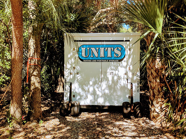 UNITS Moving and Portable Storage Container sitting between trees.