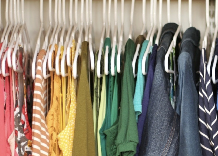 Clothes on hangers in a closet.