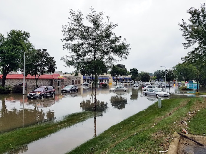 Cars in a flooded parking lot.