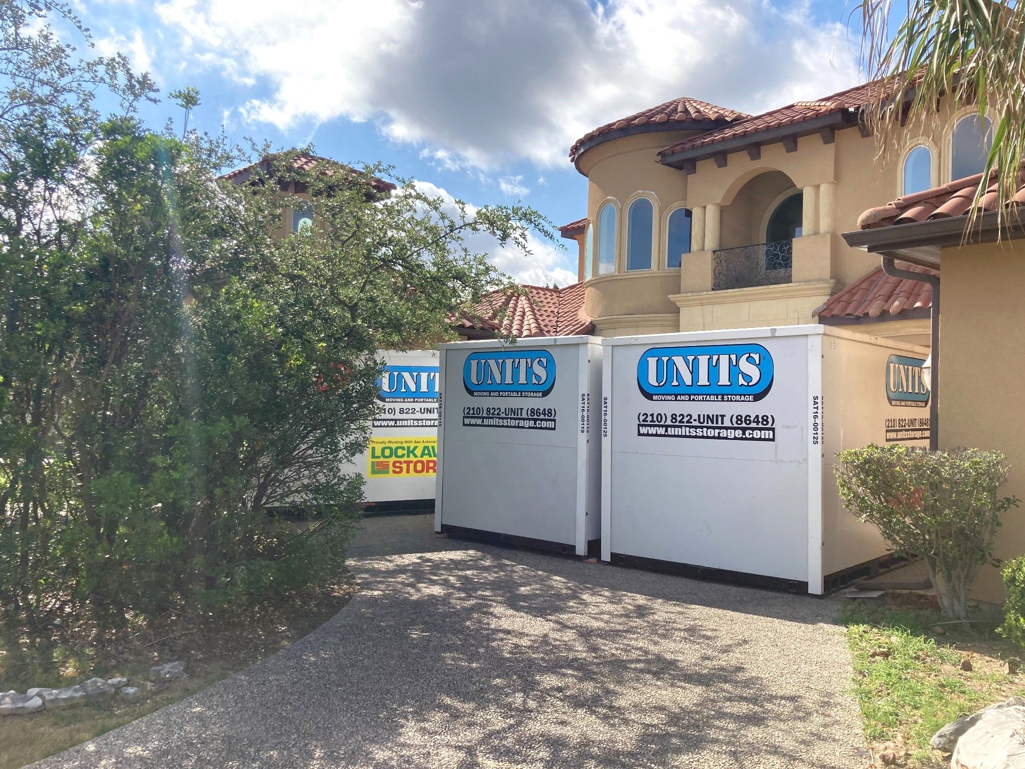 Three UNITS Moving and Portable Storage of San Antonio containers in a driveway.