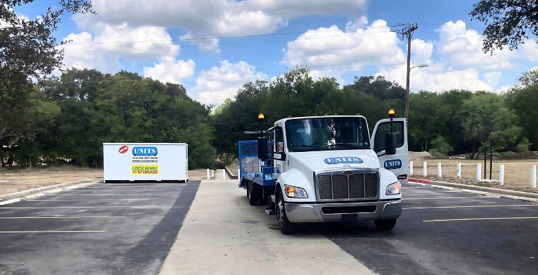 UNITS of San Antonio portable storage container and the delivery truck parked in a parking lot.