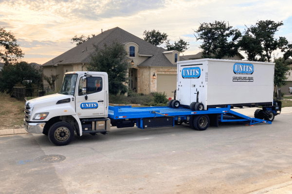 UNITS Moving and Portable Storage container being moved off the back of a UNITS truck by a ROBO-UNIT.