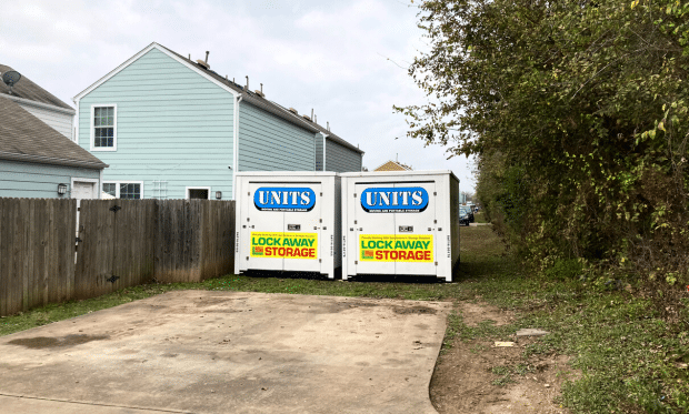 Two UNITS Moving and Portable Storage of San Diego portable storage containers behind a home.