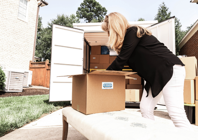 Woman packing a UNITS Moving and Portable Storage of San Diego container and boxes.