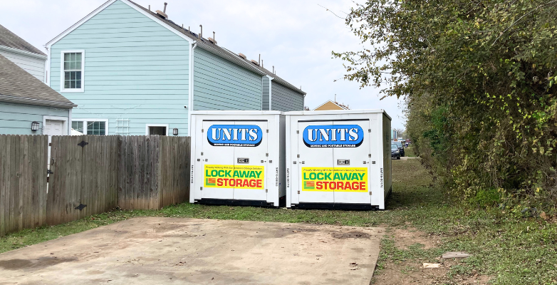 Two UNITS Moving and Portable Storage of San Diego portable storage containers behind a home.