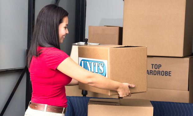 Woman loading boxes into her portable storage container.