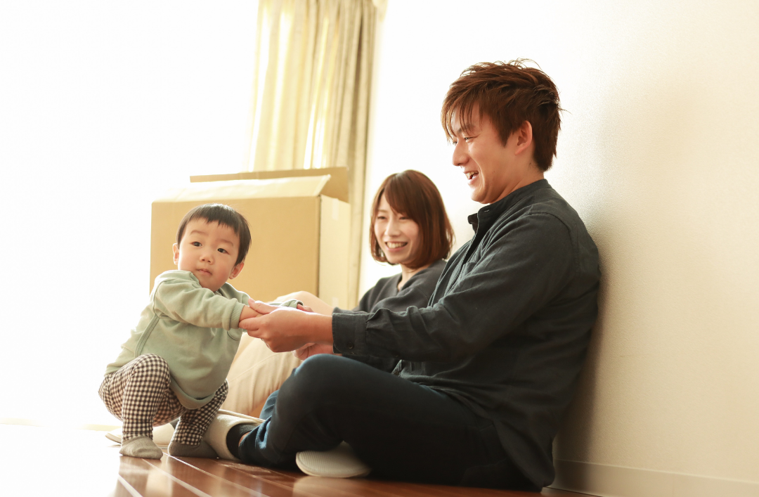 Couple sitting on the floor with their baby.