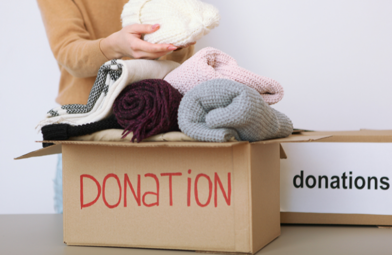 Units of Tampa Bay person putting clothes into a donation bin