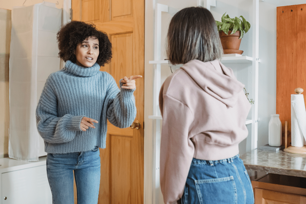 Two women arguing in a room.