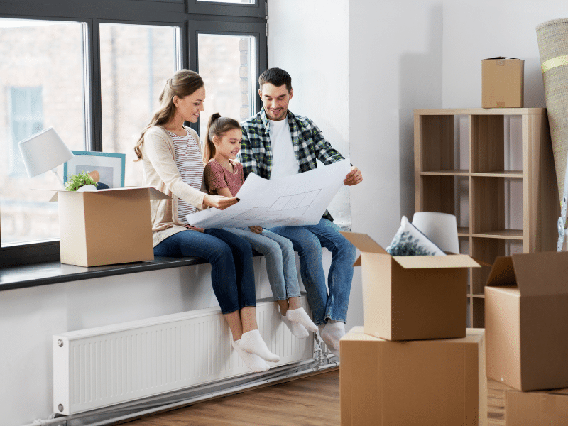 Family sitting together looking at a floor plan.