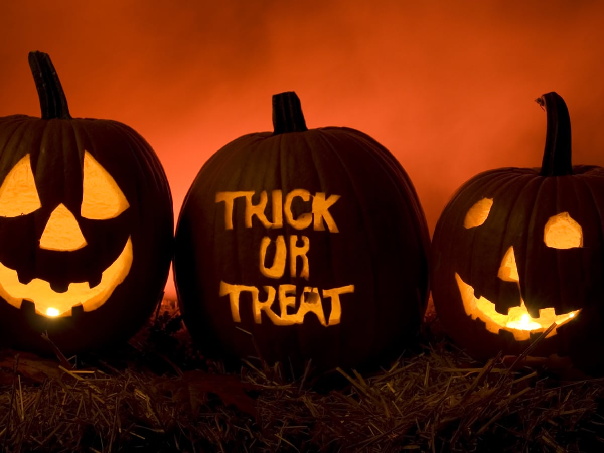 Pumpkins carved with trick of treat and faces.