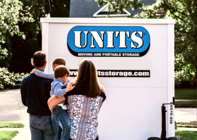 Units of Wilmington container in a driveway with a family looking at it.