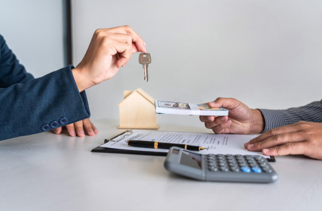 One person handing over keys in exchange for money.