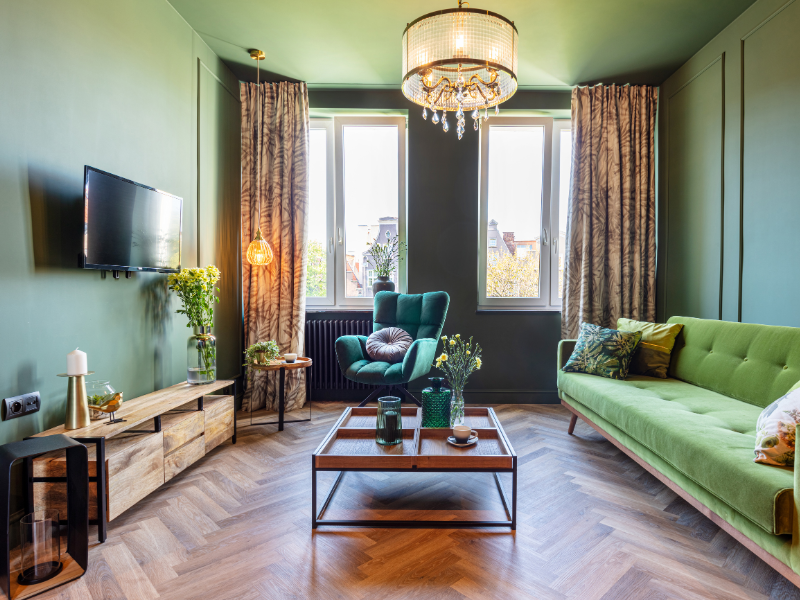 Living room decorated with green furniture and green walls.