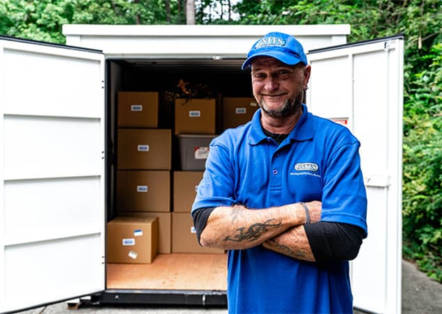 UNITS moving and portable storage mover posing outside of a container