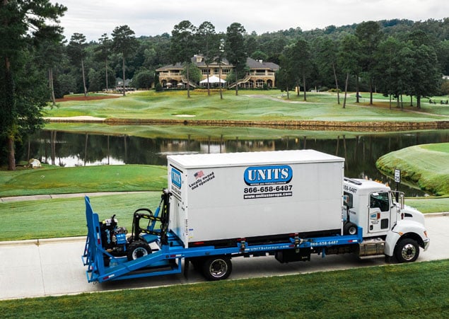 UNITS moving and portable storage truck delivering a container to a new home.