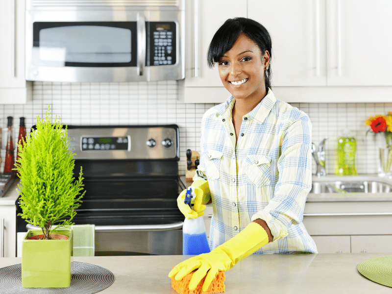 a woman Spring Cleaning her kitchen