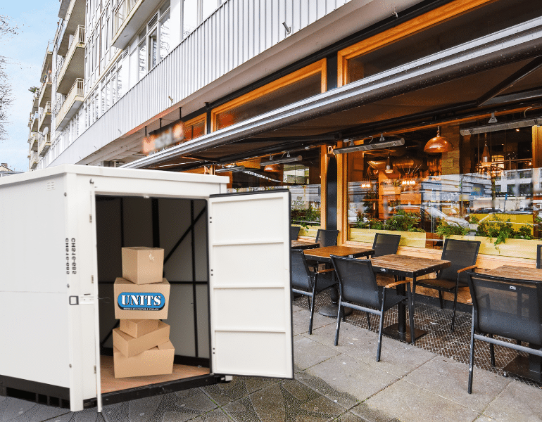 UNITS Portable storage container on the street in front of a bar at a restaurant.